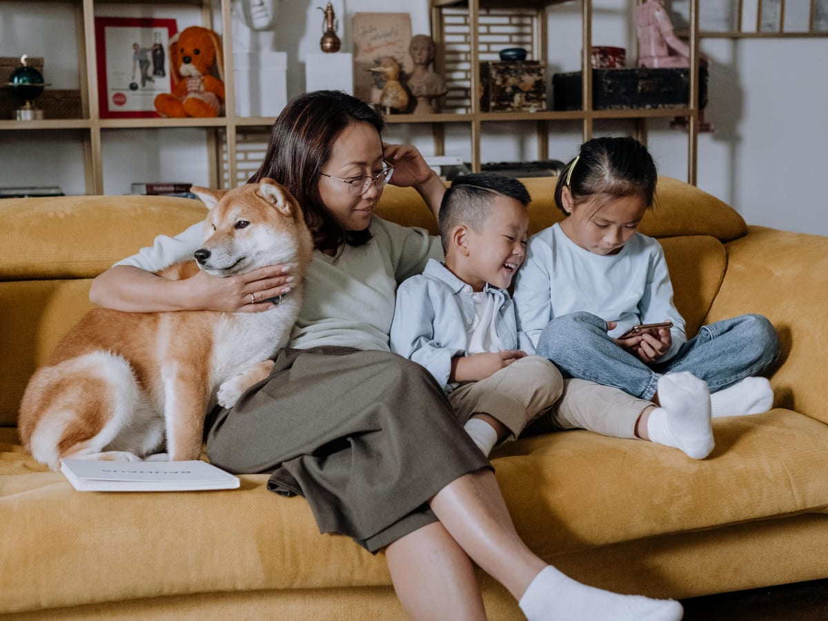 Person weighing two contract documents on a desk under soft lighting